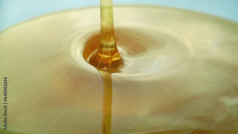 Person Pours Honey Onto Plate Closeup
Person Pours Honey Onto Plate Closeup