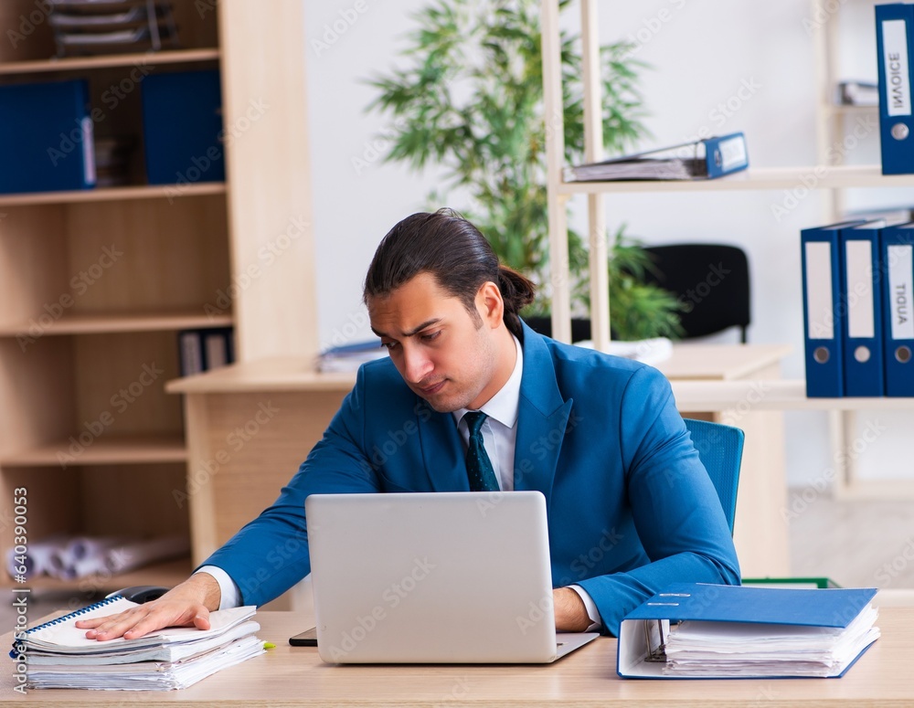 Young handsome employee sitting in the office Young handsome employee sitting in the office