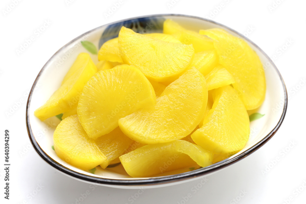 Sweet and tart slices of yellow pickled daikon, known as takuan in Japan and danmuji in Korea. Sweet and tart slices of yellow pickled daikon, known as takuan in Japan and danmuji in Korea.