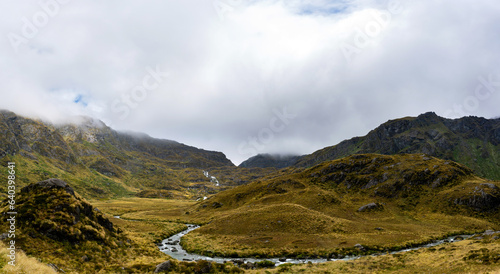 Summit of the Routeburn mountain trail with a waterfall and a river, New Zealand photo