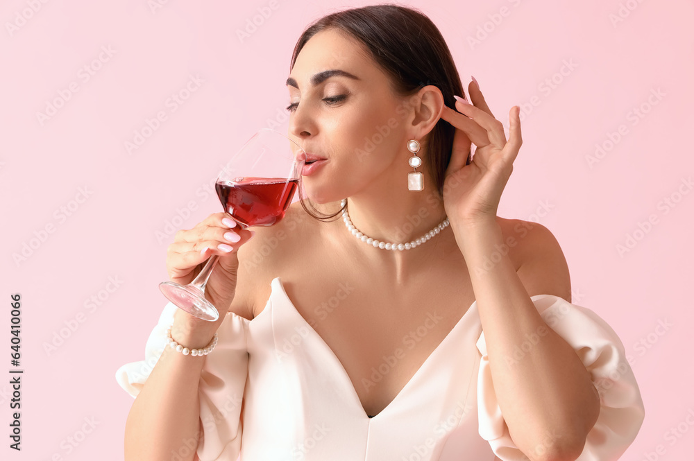 Young woman drinking wine on pink background, closeup Young woman drinking wine on pink background, closeup