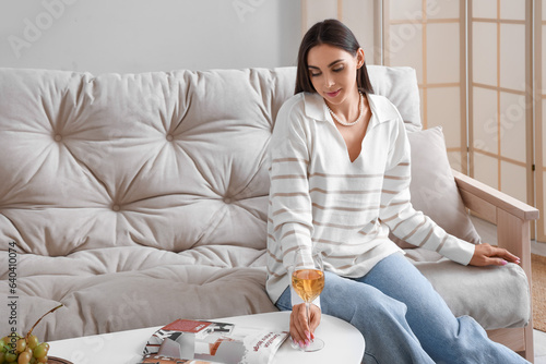 Young woman taking glass of...