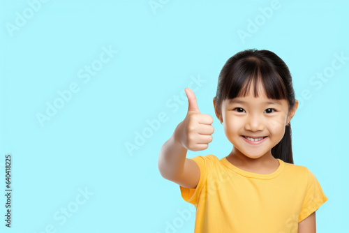 Little girl is shown giving thumbs up sign, indicating approval or agreement. This image can be used to convey positivity, success, encouragement, or support in various projects or presentations.