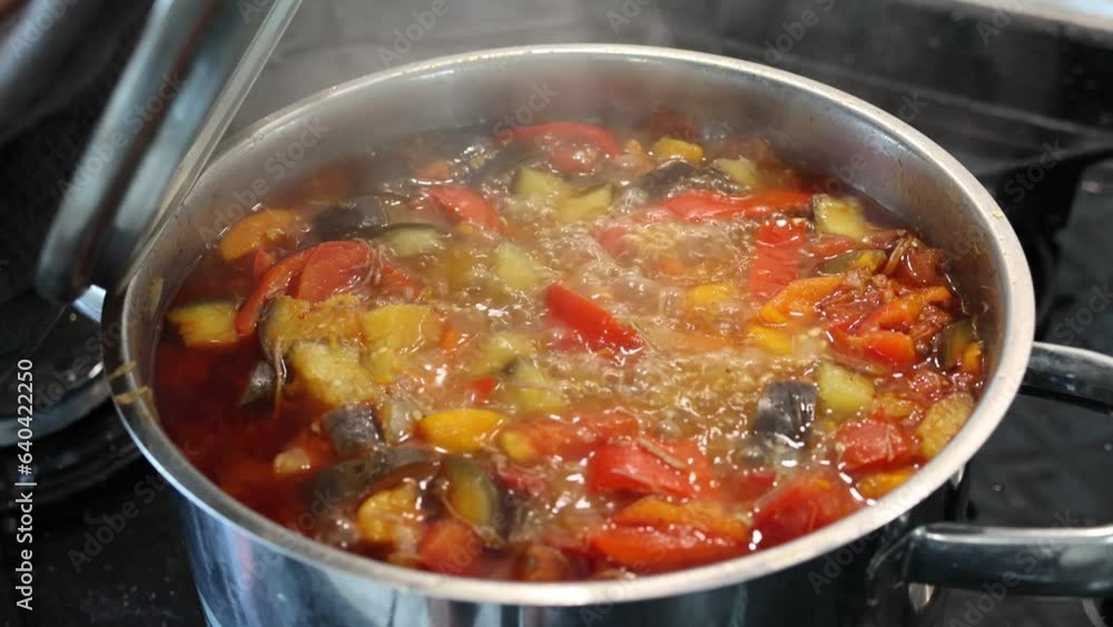 Beef lentil soup is being cooked on the stove, the cook is cooking the soup. Beef lentil soup is being cooked on the stove, the cook is cooking the soup.