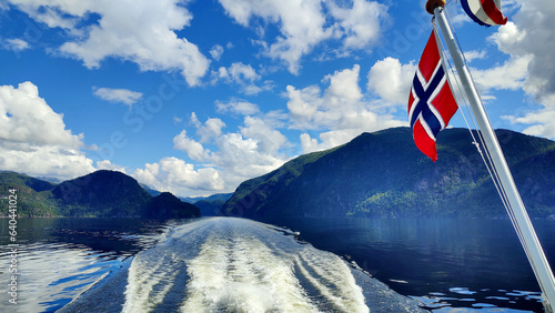 Fjord Cruise Bergen - Mostraumen, Norway. View of the fjord from the boat with Norwegian flag from the right side. Travel, Scandinavia photo