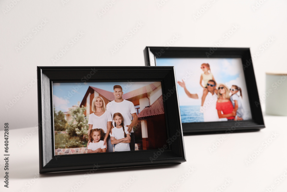 Fototapeta premium Frames with family photos on white table