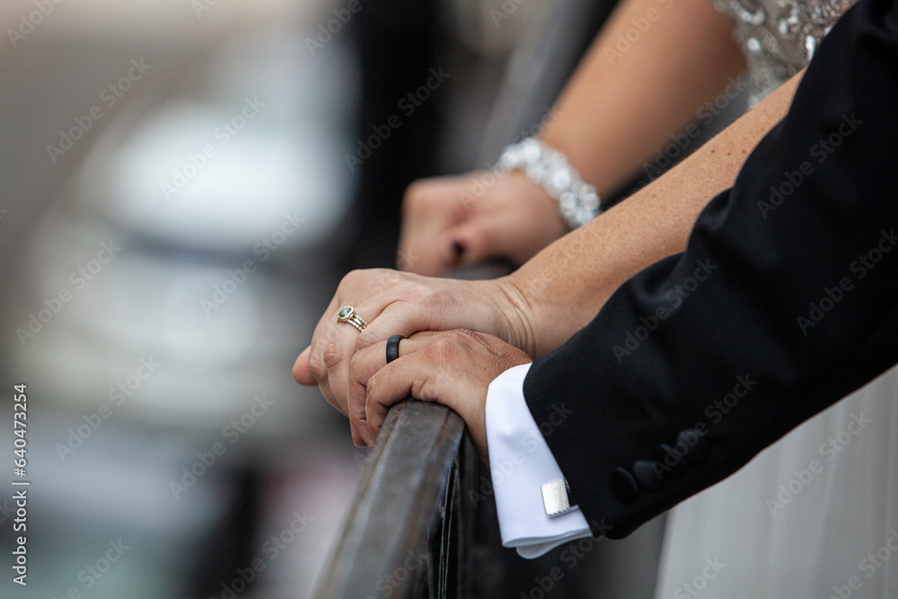 Bride and groom showing wedding rings.