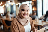 Beautiful young Muslim girl in a modern cafe. 