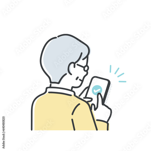 スマホを操作するシニア男性