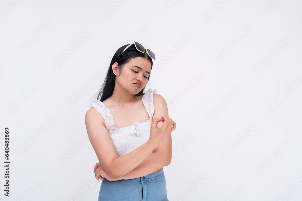 A bored asian lady checks her fingernails while waiting. Isolated on a white background. A bored asian lady checks her fingernails while waiting. Isolated on a white background.