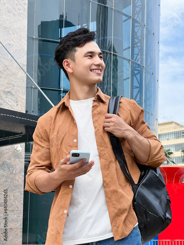 Portrait of young Asian man outside photo