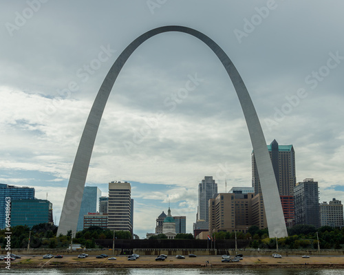 St. Louis arch viewed from the Mississippi river on a cloudy day with buildings in the background