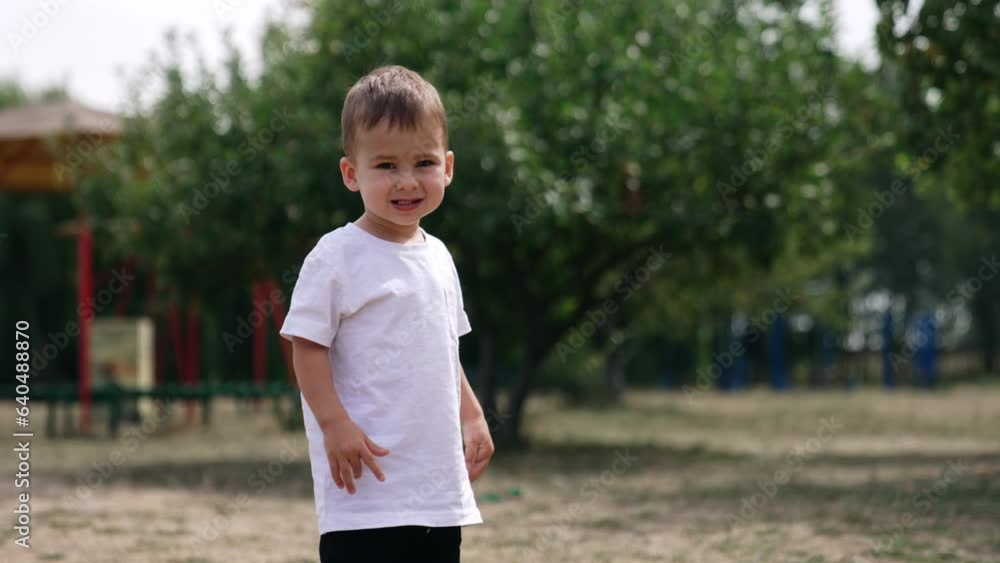 Baby boy playing in the park. Playing outdoor in park small child. Baby boy playing in the park. Playing outdoor in park small child.