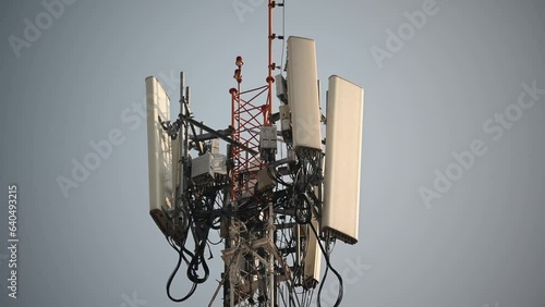 Cell tower antennas transmitting data, repeaters for mobile communications and the Internet, GPS, cellphone, 3G, 4G and 5G telecommunication tower with clear sky. photo