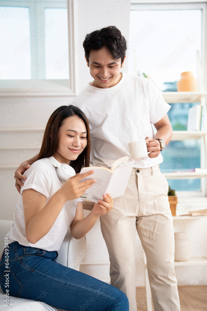 Photo of young Asian couple at home