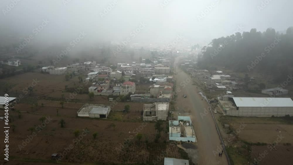 Aerial enters sleepy, foggy mountain town in rural Guatemala valley Aerial enters sleepy, foggy mountain town in rural Guatemala valley