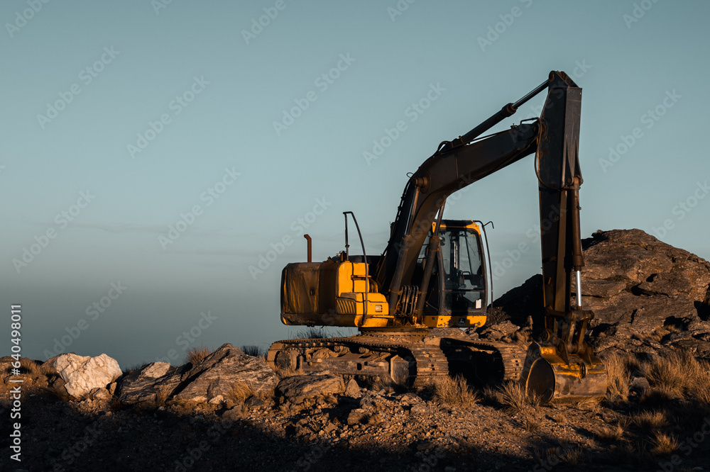 Shaping the Peaks: Dynamic View of an Excavator at Work in the Mountains