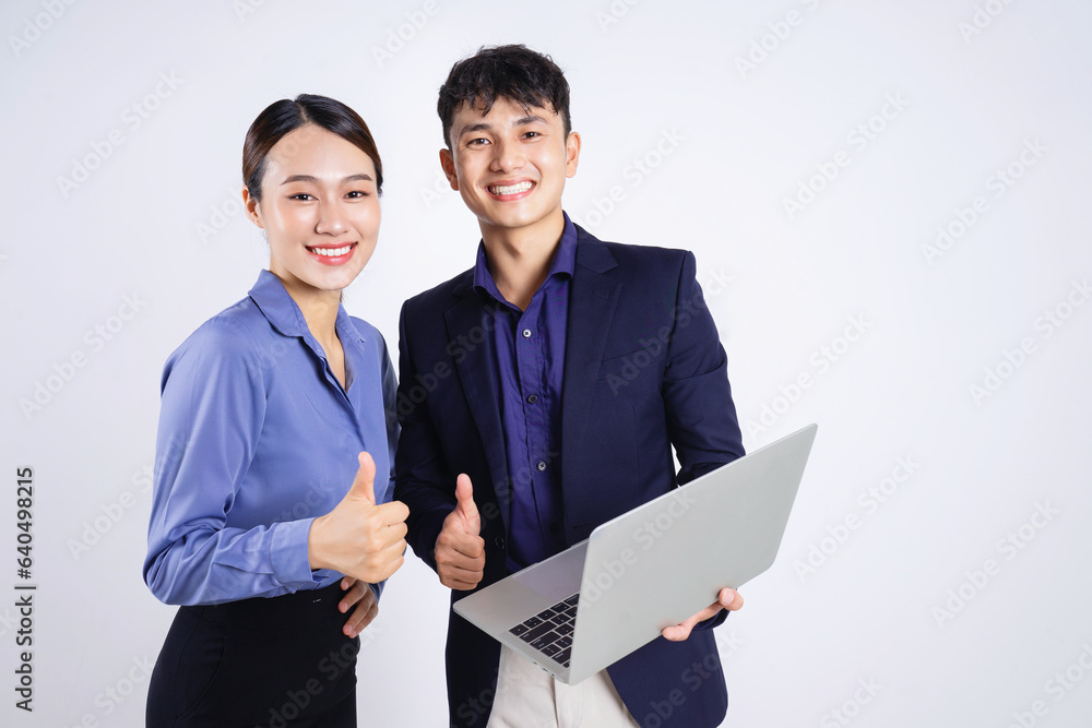 Photo of two young Asian business people on white background Photo of two young Asian business people on white background