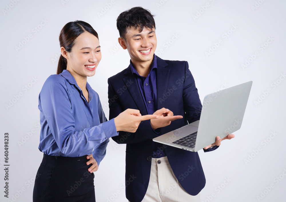Photo of two young Asian business people on white background Photo of two young Asian business people on white background