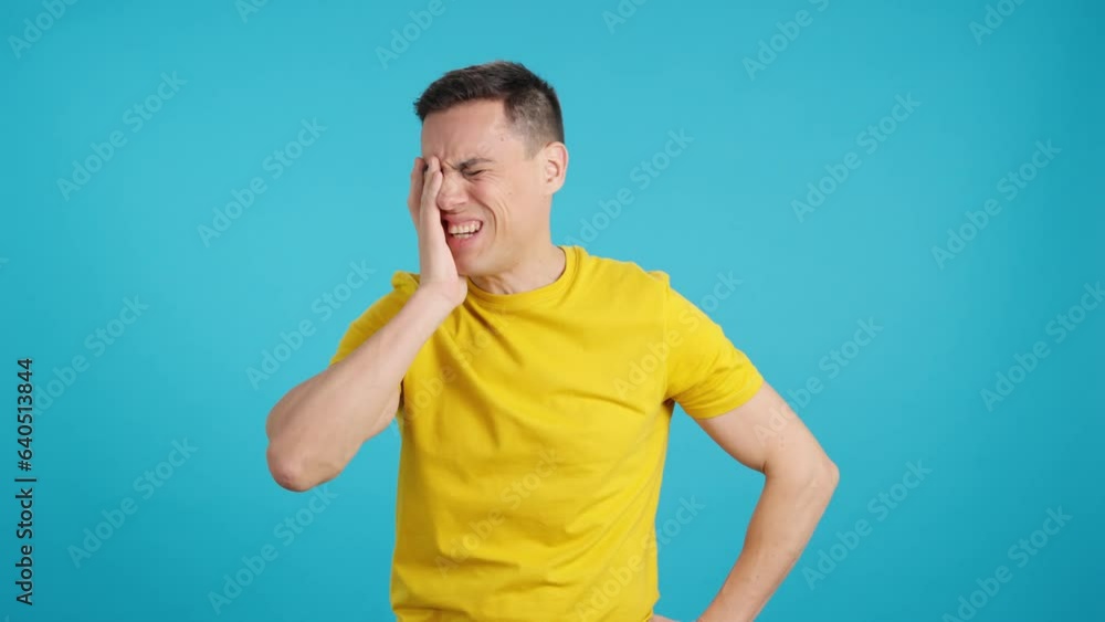 A caucasian casual man standing gesturing headache A caucasian casual man standing gesturing headache