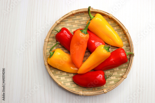 Vibrant chilli peppers. Assorted colorful varieties of hot and sweet peppers or chilies on a farm background. copy space. 