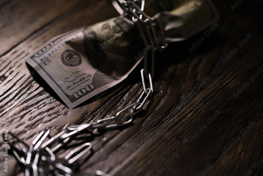 The American currency is dollars, tied with a chain. The concept of blocking payments and transfers in foreign currency. The American currency is dollars, tied with a chain. The concept of blocking payments and transfers in foreign currency.