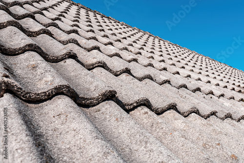 Concrete roof tiles with blue sky in background © Bits and Splits