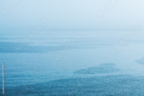 Summer shower rain at Croatian Adriatic sea shoreline, minimalistic landscape background