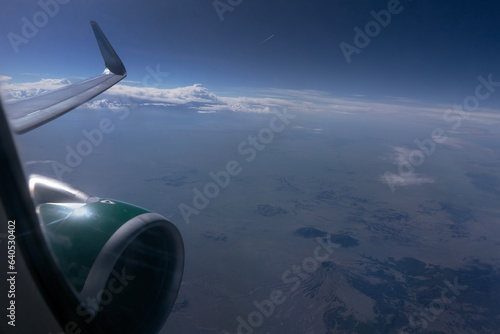 View out plane window at Earth and atmosphere
