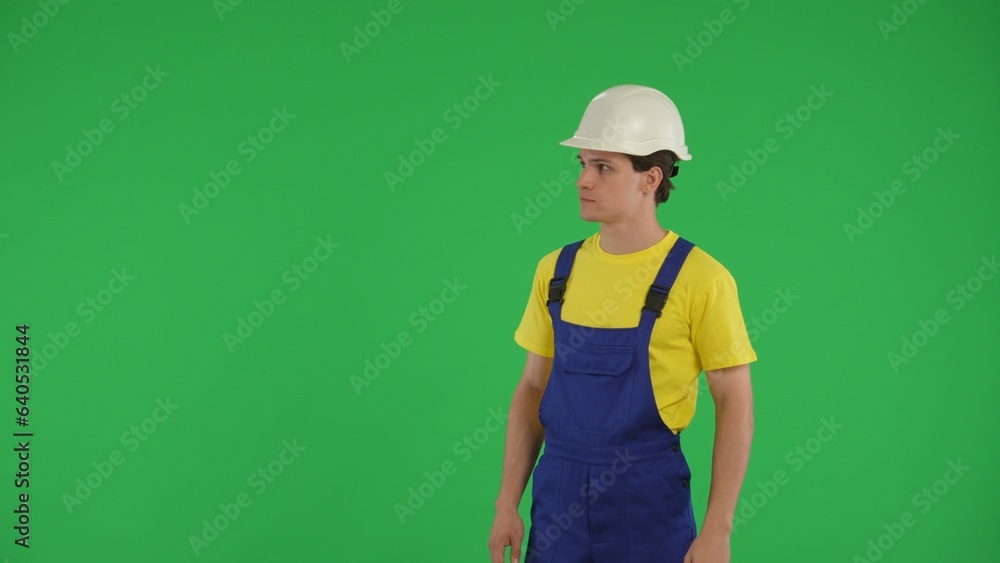 Medium green screen isolated chroma key shot of a young construction worker looking around, checking the surroundings. Medium green screen isolated chroma key shot of a young construction worker looking around, checking the surroundings.