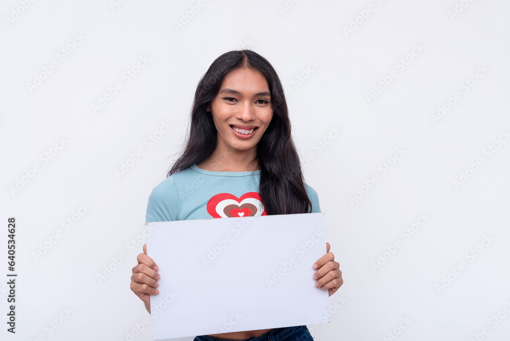 A confident young Asian trans woman smiling pleasantly while holding a white blank signage. Isolated on a white background. A confident young Asian trans woman smiling pleasantly while holding a white blank signage. Isolated on a white background.