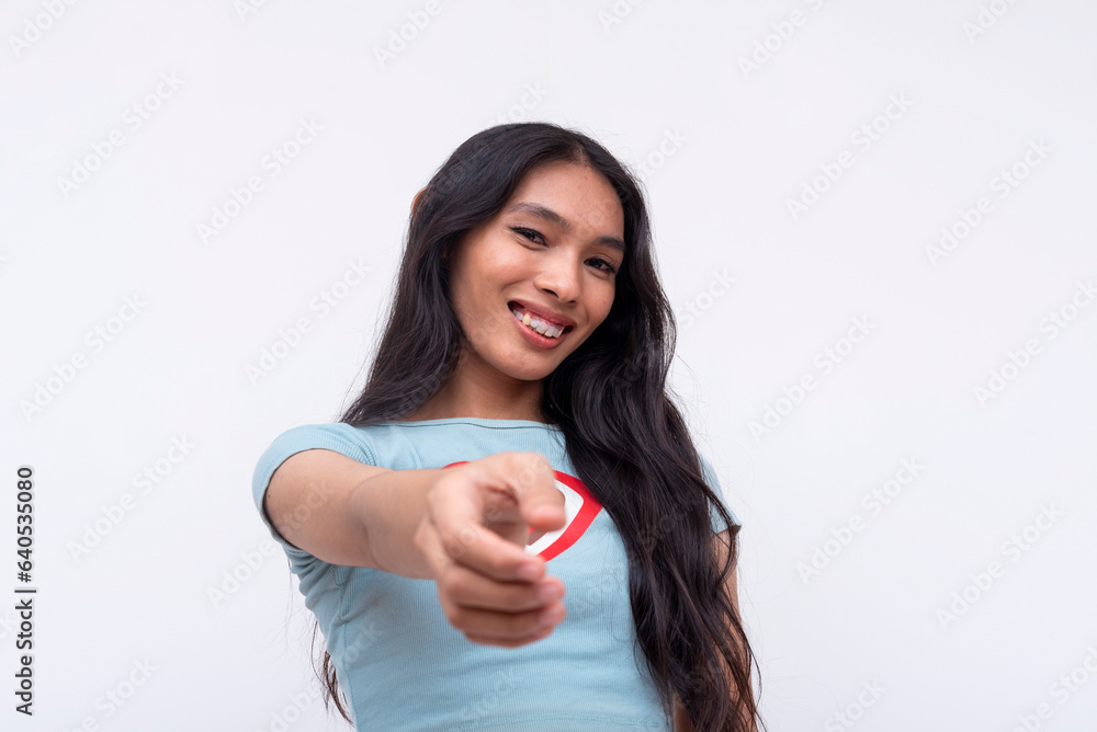 A confident asian trans woman pointing to the camera nominating someone. A handpicked choice. Isolated on a white background. A confident asian trans woman pointing to the camera nominating someone. A handpicked choice. Isolated on a white background.