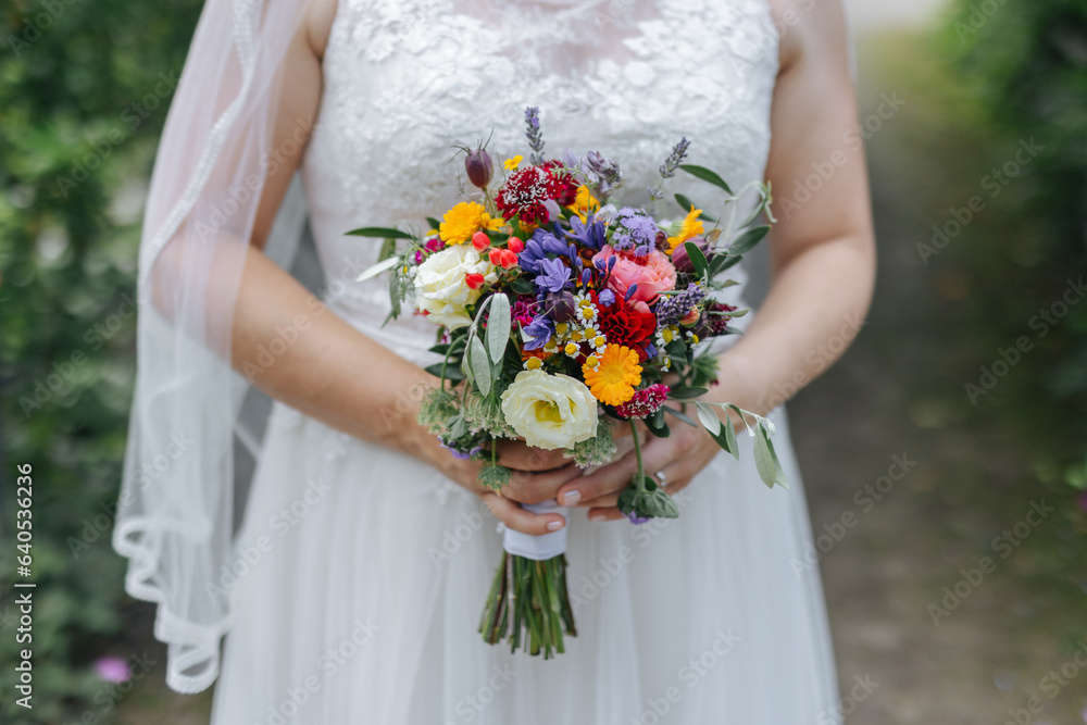 Bride holding her wedding flower bouquet in her hands close-up Bride holding her wedding flower bouquet in her hands close-up