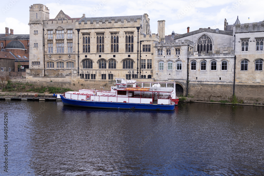 Photo of the city centre of the historic city of York in Yorkshire in the UK showing boats on the River Ouse in the British summer time on a sunny day