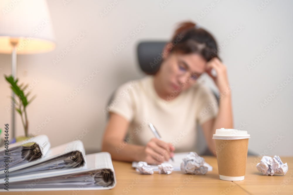 Coffee disposable cup against woman having Tired and Stressed while working, female businesswoman having headache and Migraine at office or Home late night. Overworked and Overtime Coffee disposable cup against woman having Tired and Stressed while working, female businesswoman having headache and Migraine at office or Home late night. Overworked and Overtime