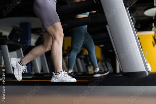 Attractive young sports woman working out in gym, cardio training on treadmill running on treadmill