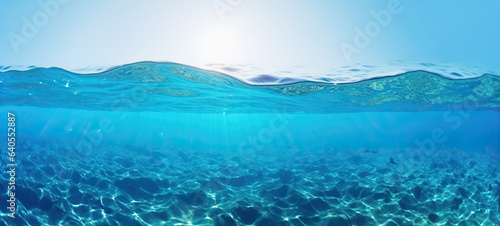 Tranquil sea water surface on a sunny day. Underwater sea in sunlight, tropical blue ocean underwater background