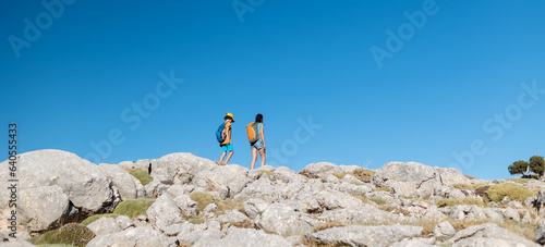 .A woman and a child are walking along a mountain path