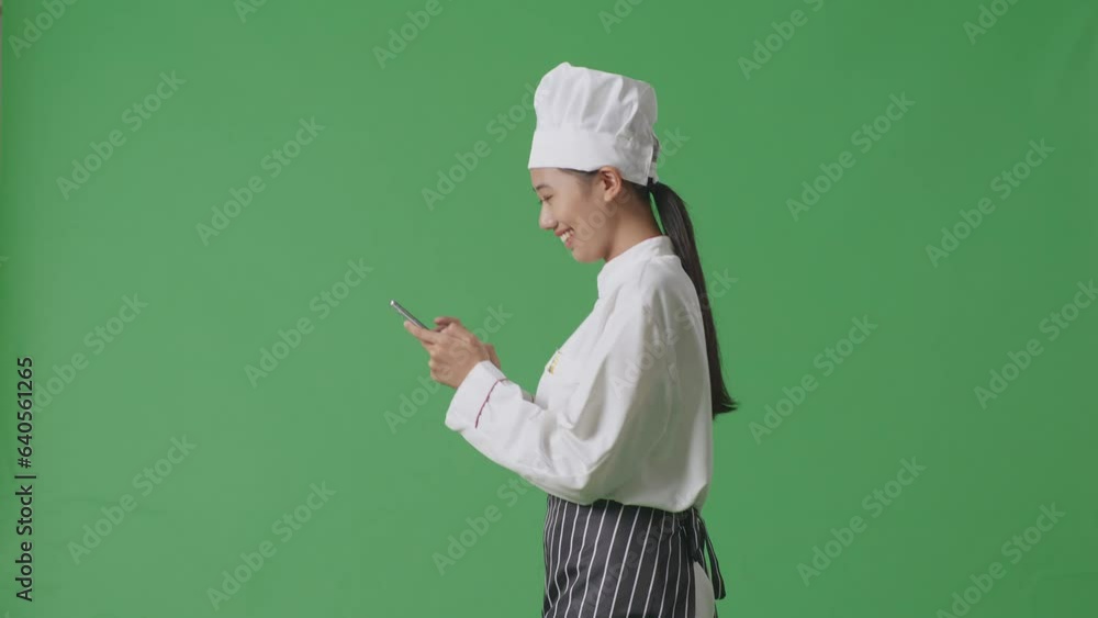 Side View Of Asian Woman Chef Walking And Using Smartphone In The Green Screen Background Studio
Side View Of Asian Woman Chef Walking And Using Smartphone In The Green Screen Background Studio