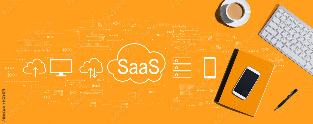 Naklejka premium SaaS - software as a service concept with a computer keyboard and office items