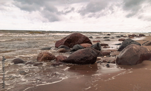Large sea stones on the seashore on a windy spring day