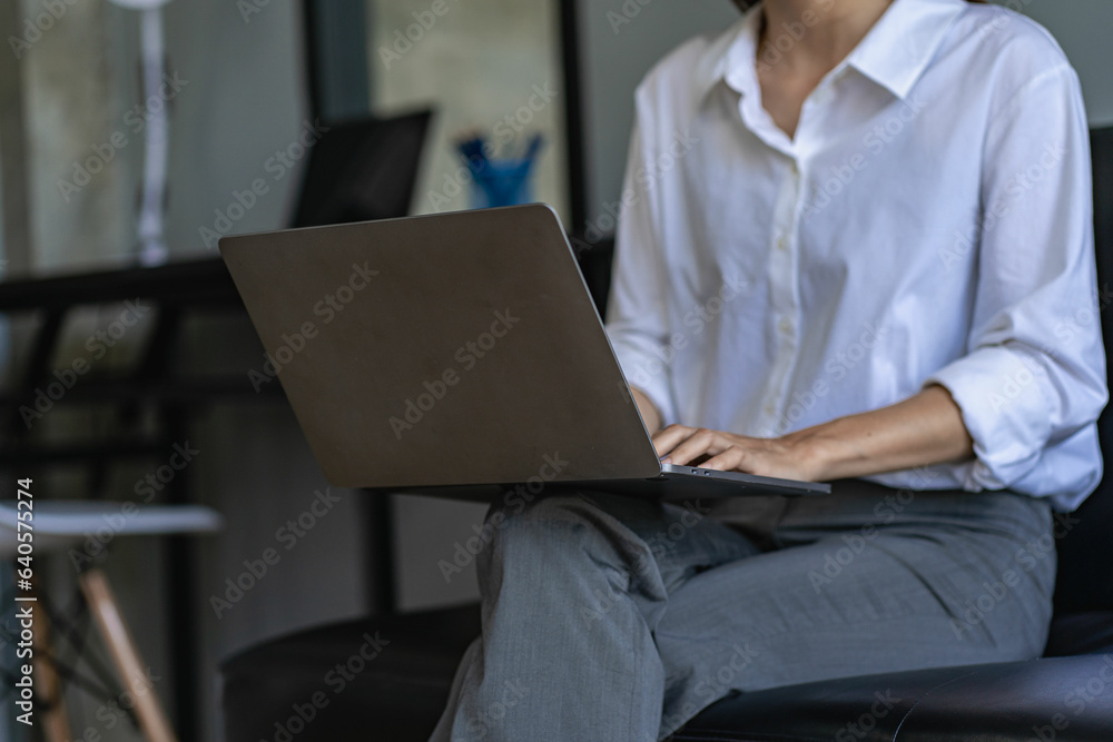Side view of business woman's hands using laptop computer resting, young woman writing in blank notebook placed on office table with laptop keyboard close up pictures Side view of business woman's hands using laptop computer resting, young woman writing in blank notebook placed on office table with laptop keyboard close up pictures