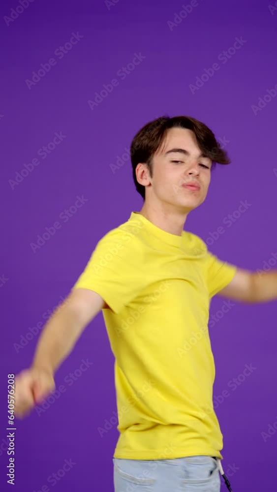 Arrogant egocentric teenager boy posing and looking at camera isolated on plain background Arrogant egocentric teenager boy posing and looking at camera isolated on plain background