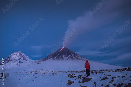 A traveler near the erupting volcano Klyuchevskaya Sopka photo