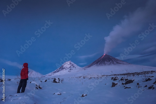 A traveler near the erupting volcano Klyuchevskaya Sopka photo