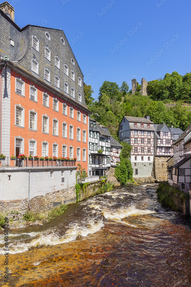 Half-timbered houses on the banks of the Rur in Monschau with the Haller ruins in the background