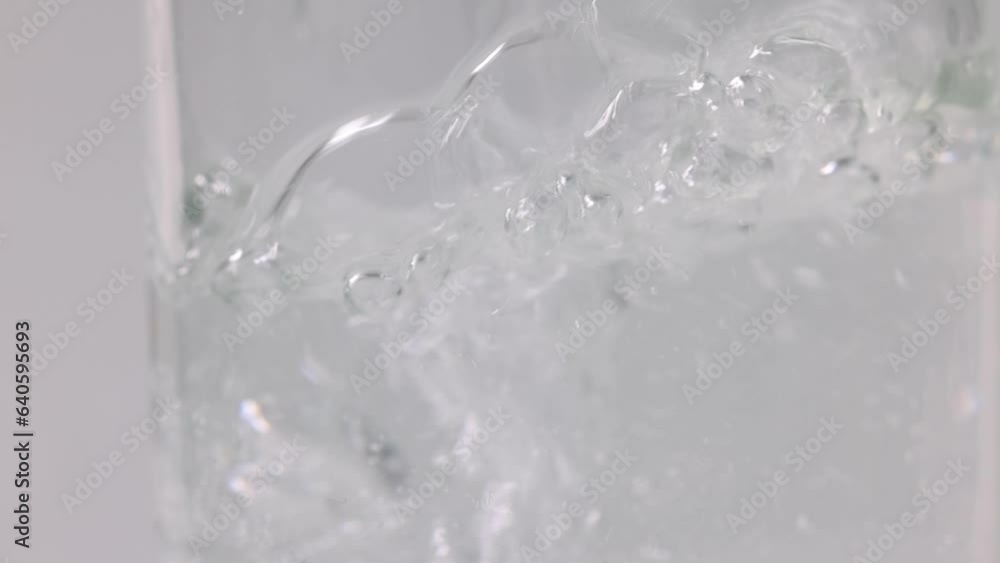 Pouring flowing water in transparent drinking glass Pouring flowing water in transparent drinking glass