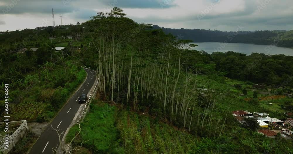 Drone view of a winding road in the village of Munduk in Bali, Indonesia Drone view of a winding road in the village of Munduk in Bali, Indonesia