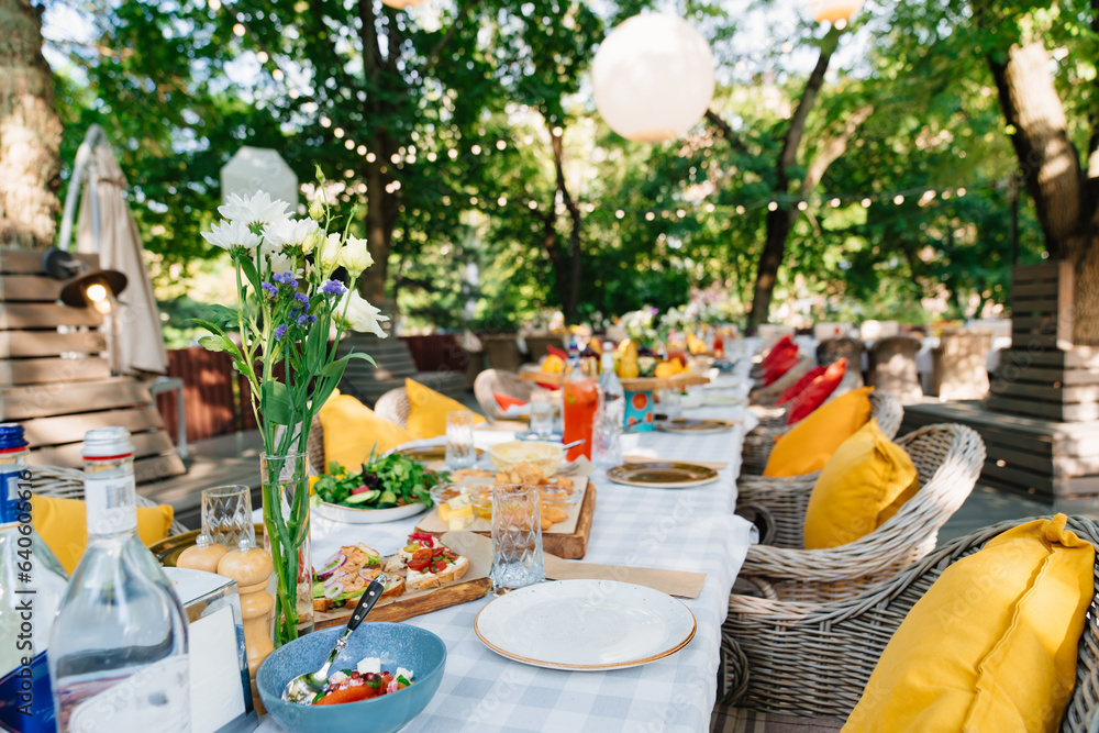 A festive table is served in the park or in the garden. 