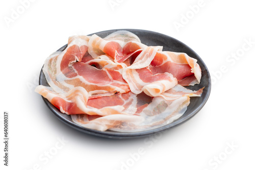 Italian panchetta piancetina. Sliced smoked bacon on plate isolated on white background. photo